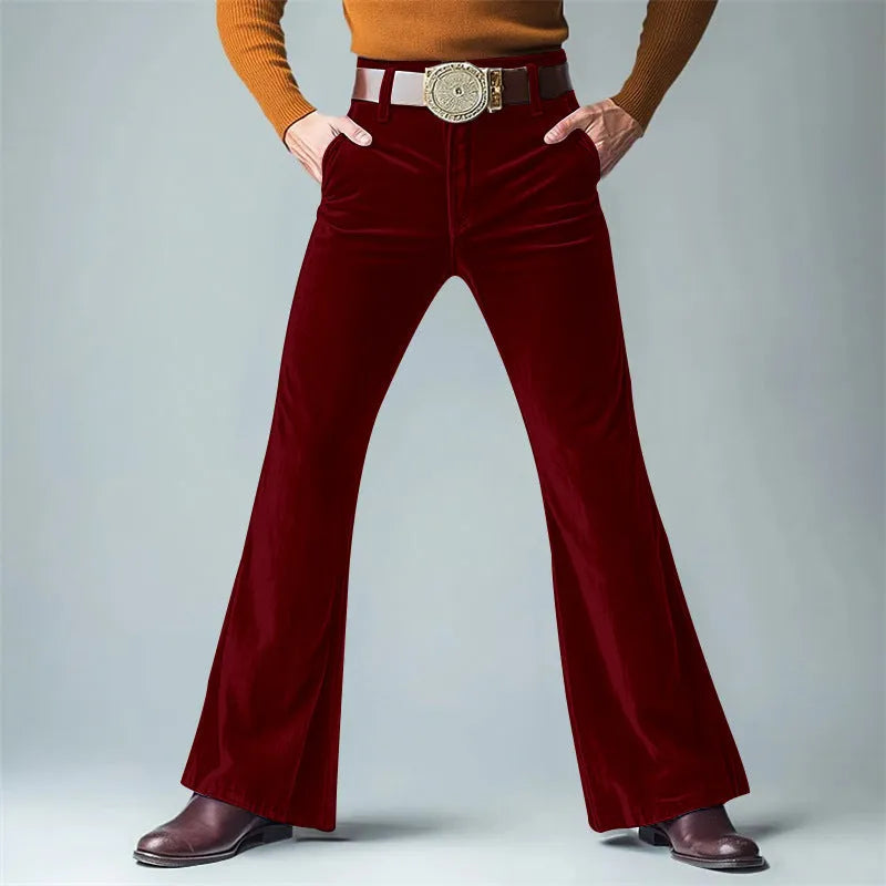 Man wearing slim flared velvet suit trousers in a dark colour for a banquet setting
