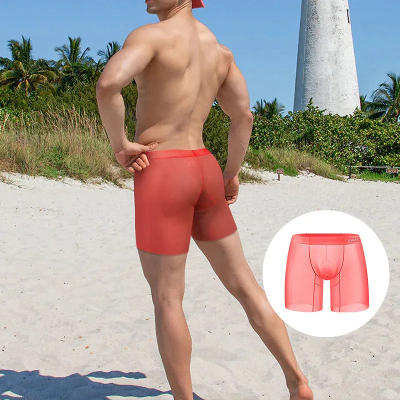 Solid colour men's low waist boxer shorts in ice silk nylon fabric, shown in orange, pink, and red.