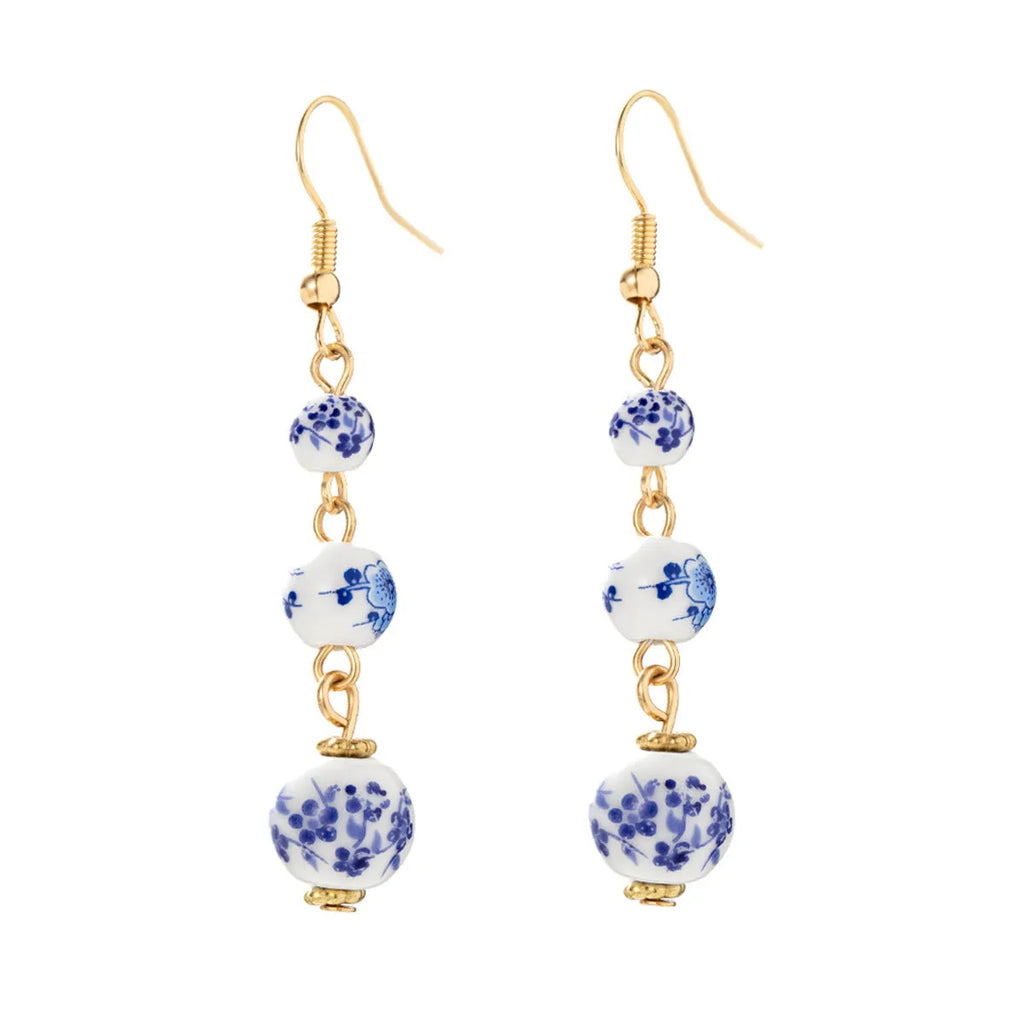 Long blue and white porcelain ceramic bead earrings with geometric Chinese-style design.