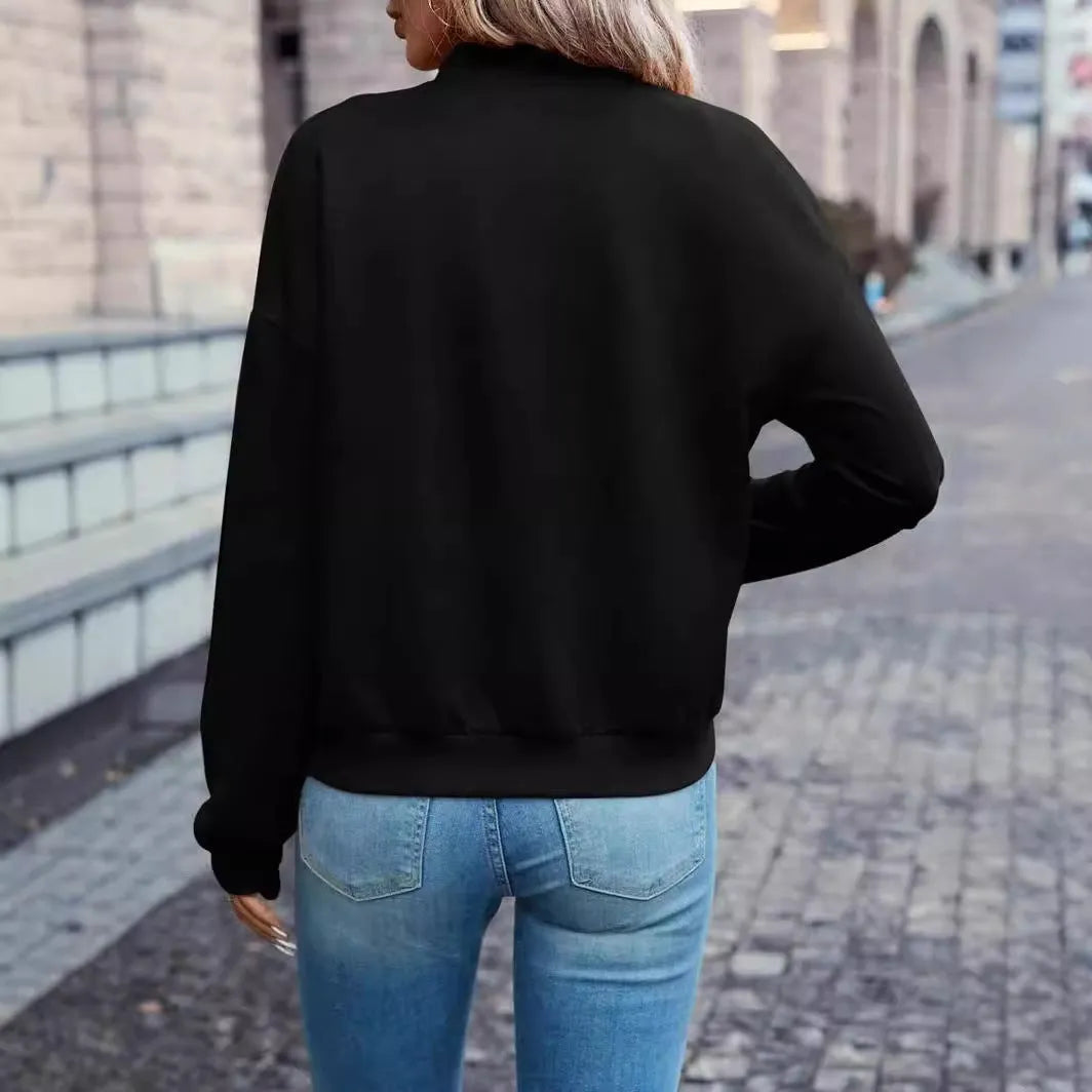 Black women's casual zip jacket with long sleeves on a hanger