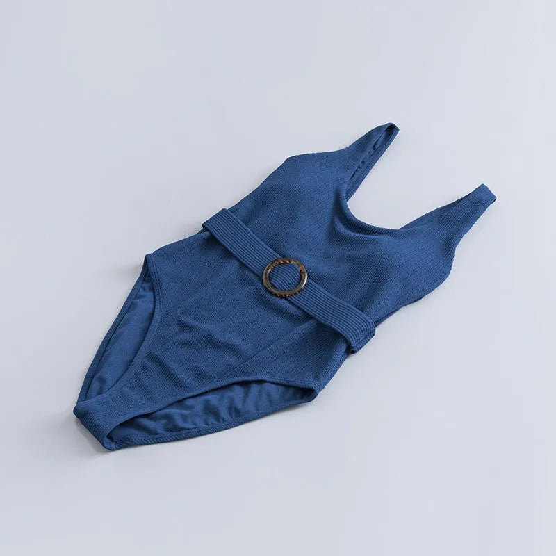 Navy blue women's one-piece swimsuit with triangle design and chest padding on a mannequin.