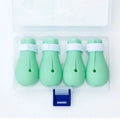 Set of four green silicone cat paw covers used for anti-scratch protection during washing and medicine