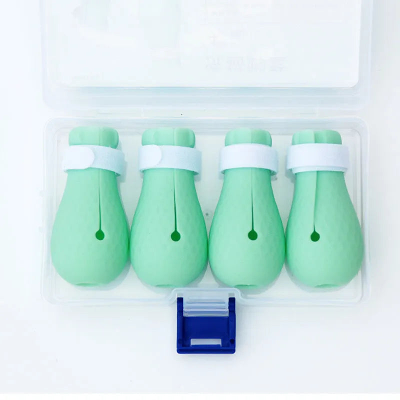 Set of four green silicone cat paw covers used for anti-scratch protection during washing and medicine