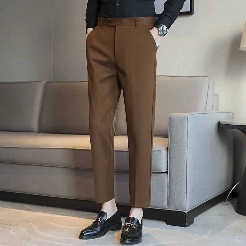Straight leg brown corduroy trousers for men laid flat, showing texture and elastic waistband.