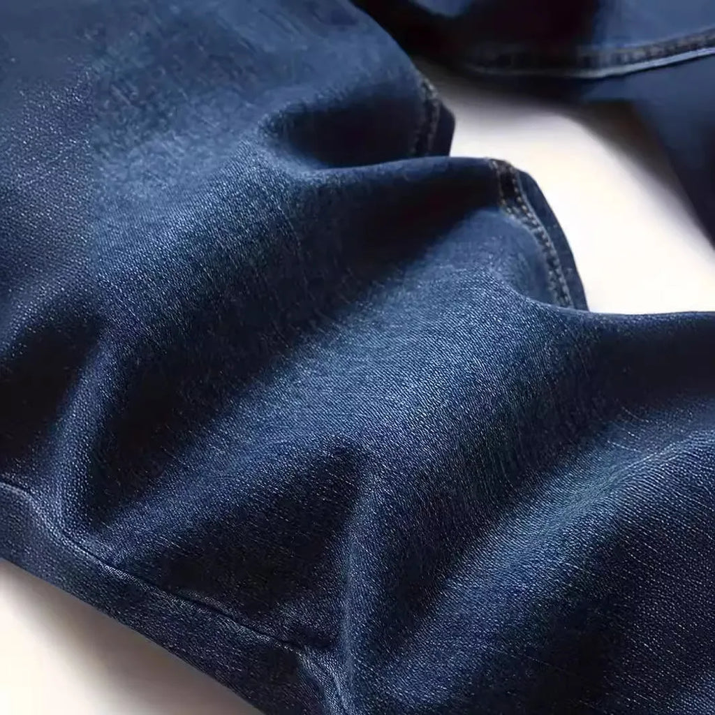 Men's dark blue cotton skinny jeans with elastic waistband shown on model