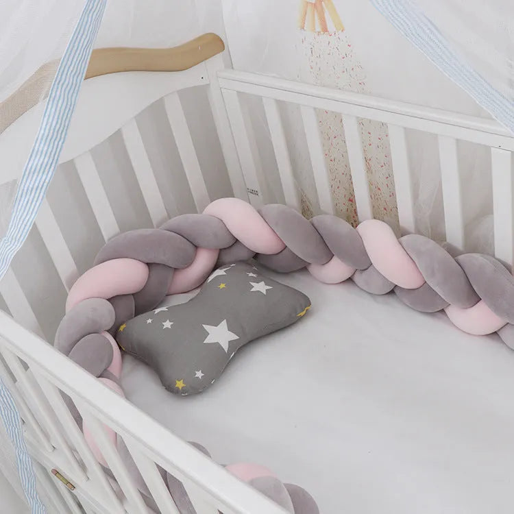 Braided knot design baby crib bumper in spandex velvet, shown in a light grey colour.