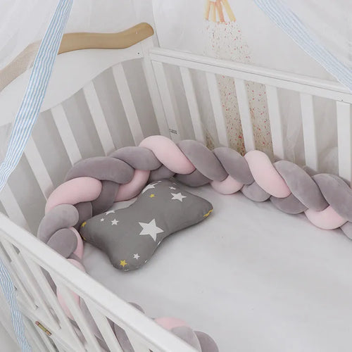Braided knot design baby crib bumper in spandex velvet, shown in a light grey colour.