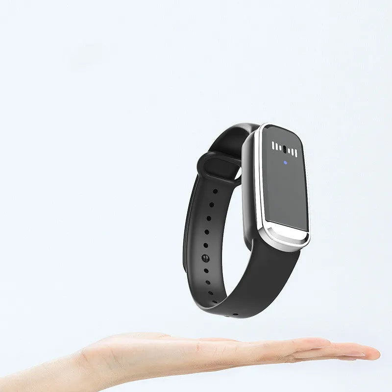 Black and white ultrasonic mosquito repellent bracelet on a wrist, showing compact design with USB charging port.
