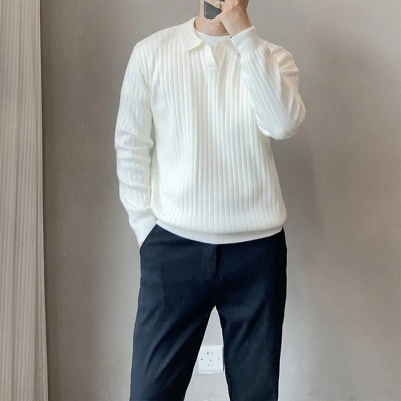 Man wearing a black and white striped knitted jumper with a lapel collar.