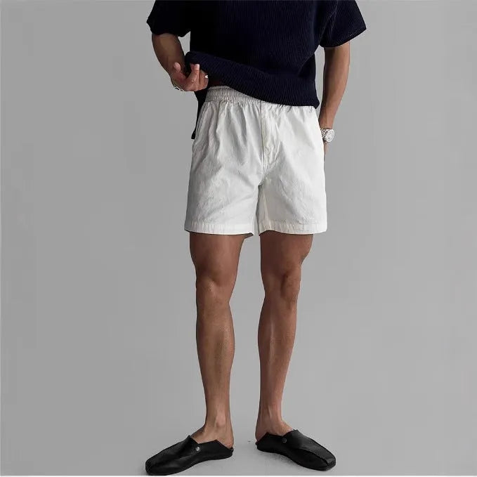 Men's cotton loose fit sports shorts in black colour showing elastic waistband with drawstring