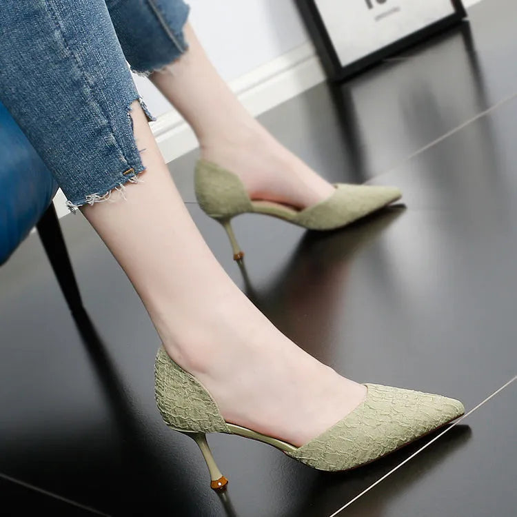 Women's black pointed toe stiletto high heels with a stiletto heel on a plain background.