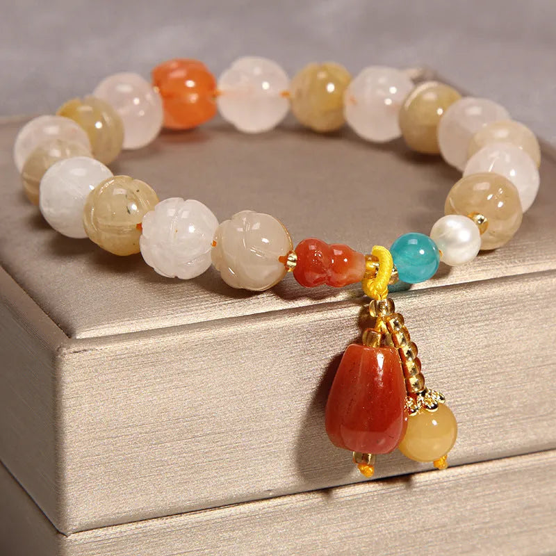 Yellow agate crystal bead bracelet with khaki silk cord and gold tone sliding closure.
