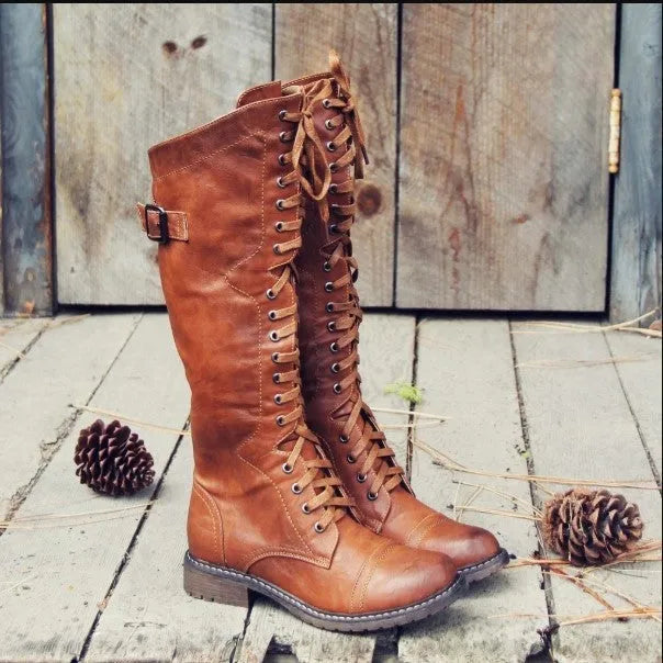 Women's cross strap knight boots in solid colour artificial PU, available in red black brown sizes 36-43