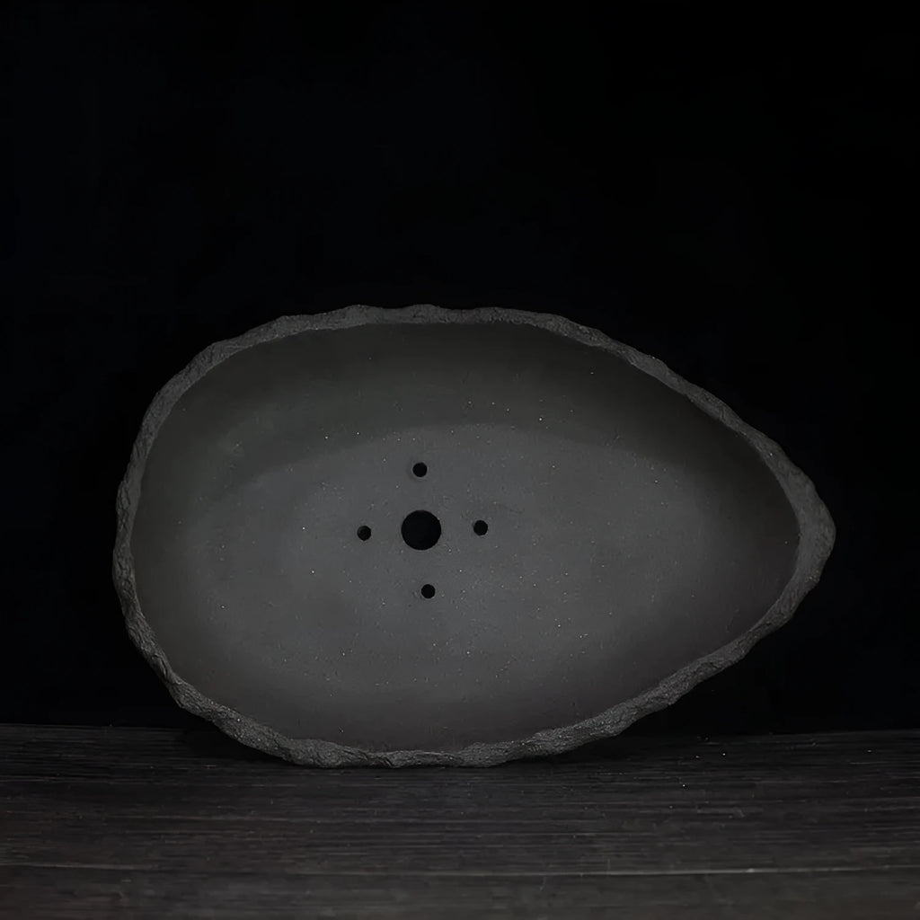 Handmade purple clay floor-standing flower pot showing texture and form, suitable for large indoor plants.