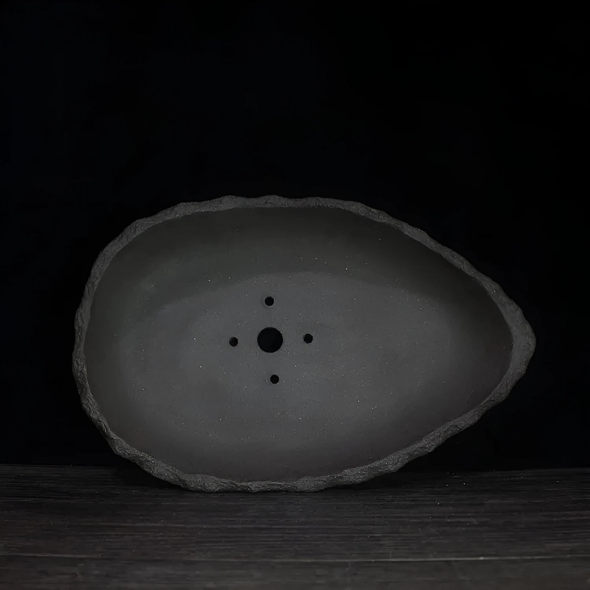 Handmade purple clay floor-standing flower pot showing texture and form, suitable for large indoor plants.