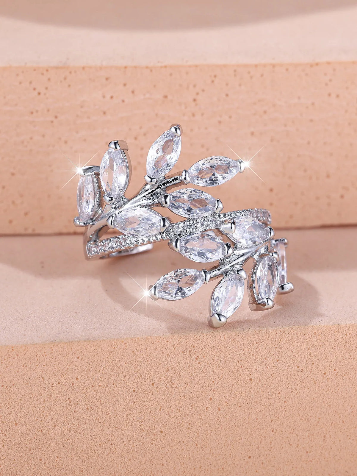 Adjustable horse eye zircon leaf ring in rose gold or platinum plating on a model's hand.