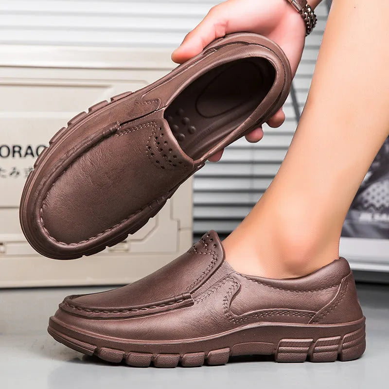 Men's black slip-on casual shoes with a round toe and chunky waterproof platform sole.