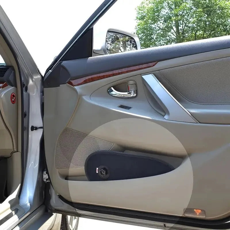 Black stretchy car side window sun shade with suction cups, installed on a car window.