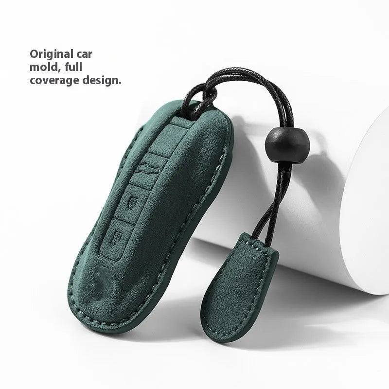 Suede car key cover in cement grey, dark green, light grey, and orange colour options