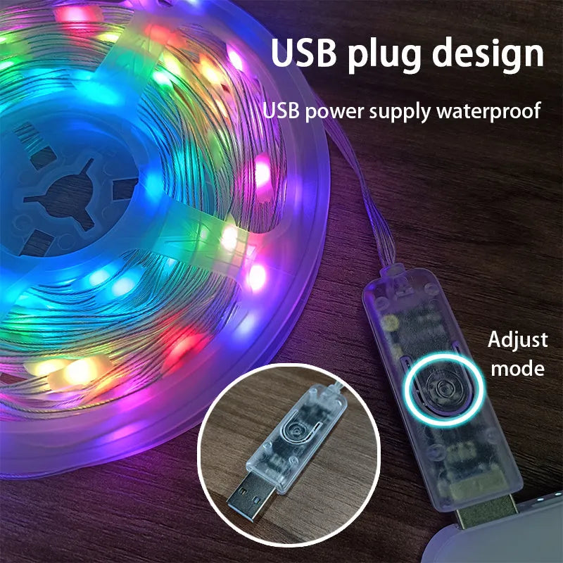 10 metre long LED festival light string with 100 warm white bulbs coiled on a table next to its remote control.