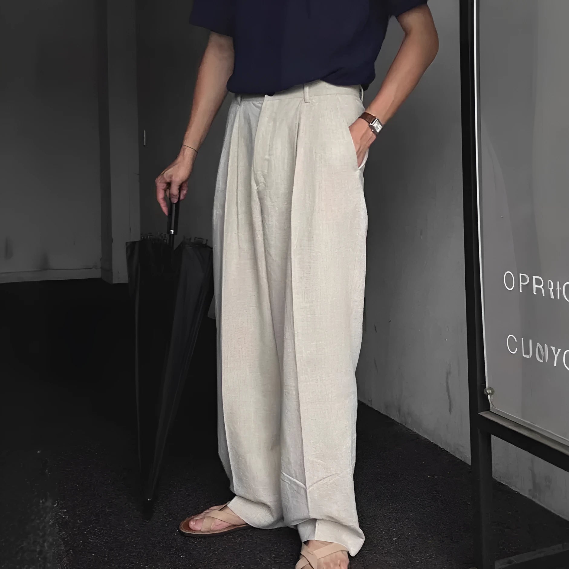 Men's apricot-coloured wide-leg cotton linen trousers with an elastic waistband on a hanger.