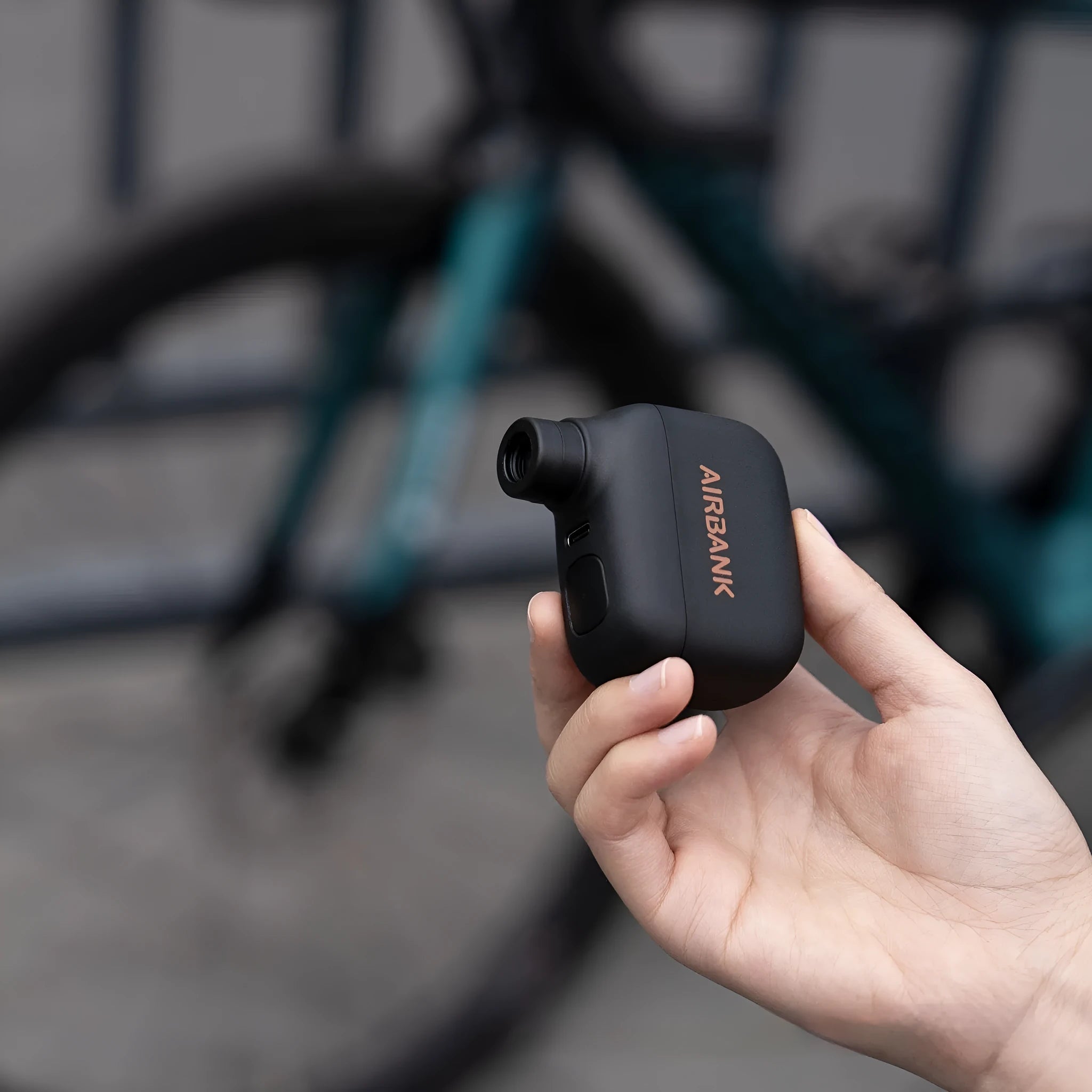 Black AS100 electric bicycle pump with USB charging port showing compact dimensions