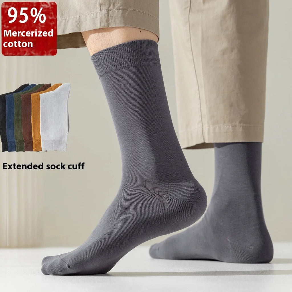 A pair of solid colour men's mid-calf socks in combed cotton, shown in a light grey shade.