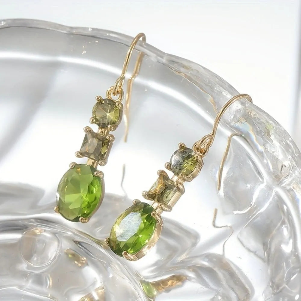 A pair of green geometric quadrilateral copper earrings in a bohemian style for unisex wear.