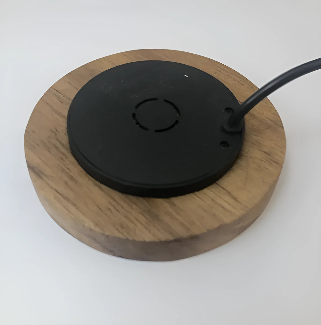 Black round 60mm wireless charging pad for embedded installation in desks and furniture.