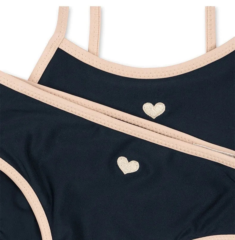 Dark blue split-style briefs swimsuit for baby girls, shown in sizes from 90cm to 130cm.