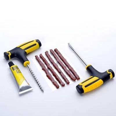 Vacuum tyre repair tool 8-piece set showing tyre probe, rubber strips, glue and pin for puncture repair