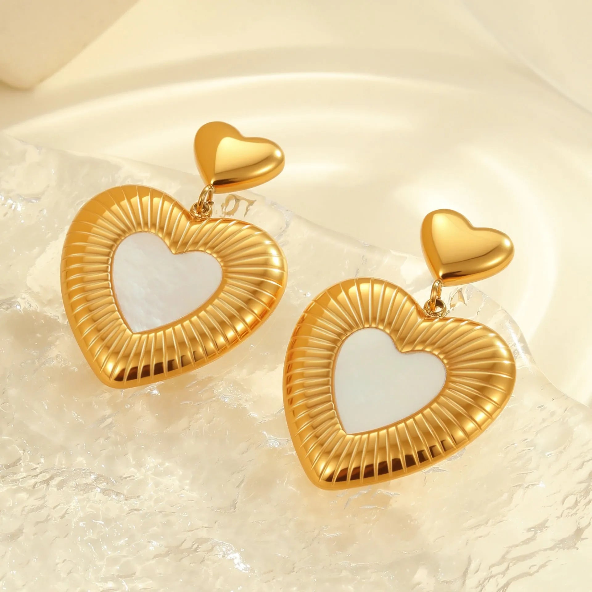 Stainless steel heart-shaped earrings with white fritillary design and 18K gold electroplating finish