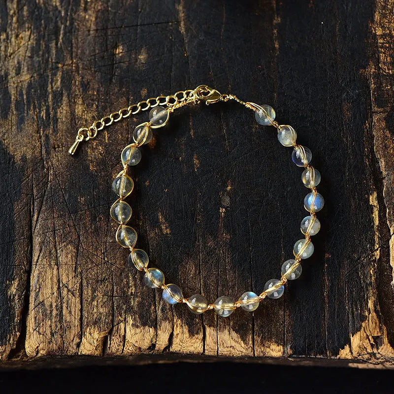 Women's bracelet with blue moonstone beads and gold-gilded metal in a starry sky design.