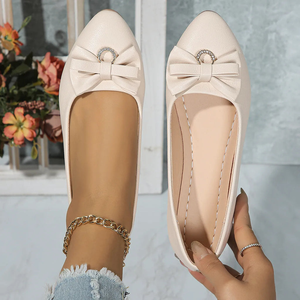 Women's beige casual flat slip-on shoes with a bowknot and shallow mouth design on a rubber sole.