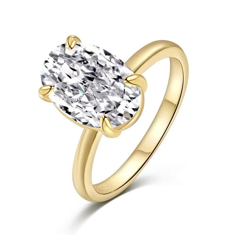 Oval women's ring with four-claw setting holding a 6x9mm gemstone on a silver band