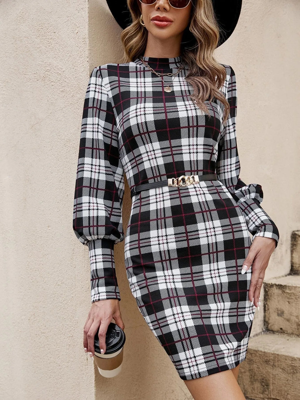 Black women's tight dress with voluminous lantern sleeves and decorative leather stitching details.