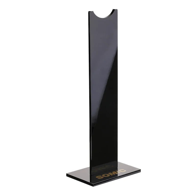 Black detachable head-mounted gaming headset bracket stand on a desk