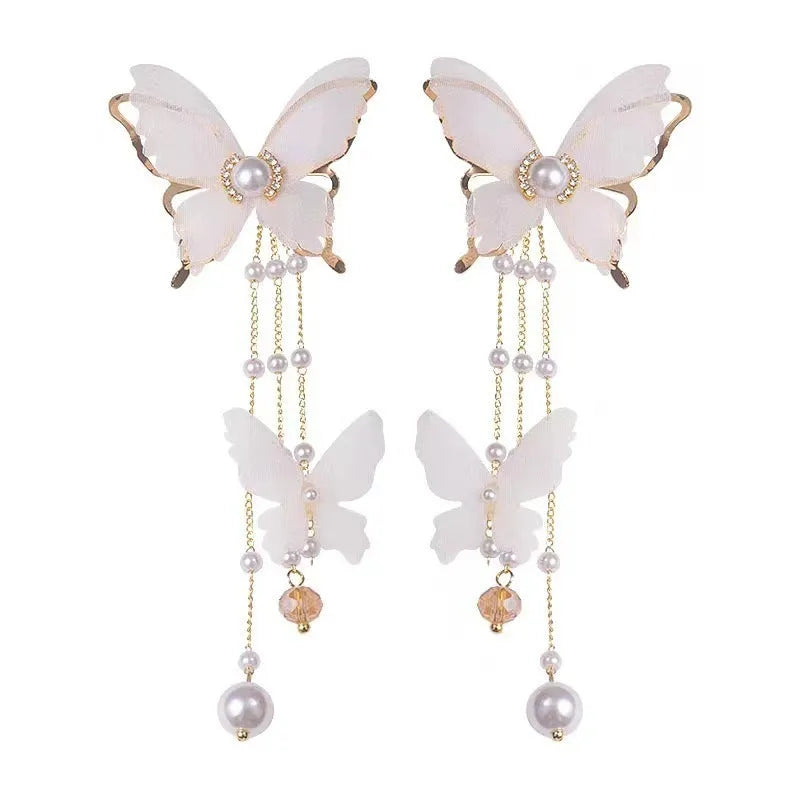 White butterfly earrings with rhinestone and pearl accents on copper alloy with lace tassels