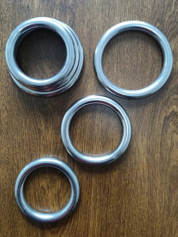 A silver-coloured carbon steel Wing Chun training ring for martial arts strength conditioning.