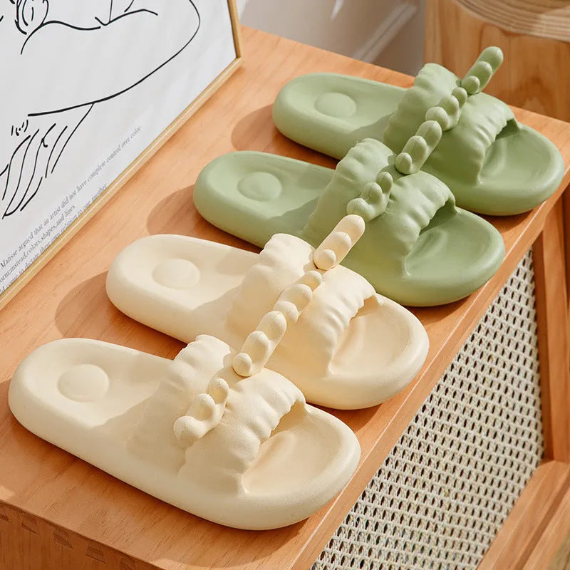 Pair of light-coloured EVA flip flop slippers with hollow-out design and textured sole.