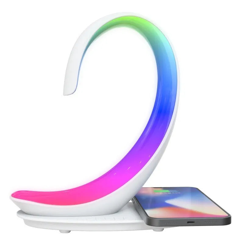 White swan-shaped desktop device with wireless charging pad, Bluetooth speaker, and colourful atmosphere lighting.
