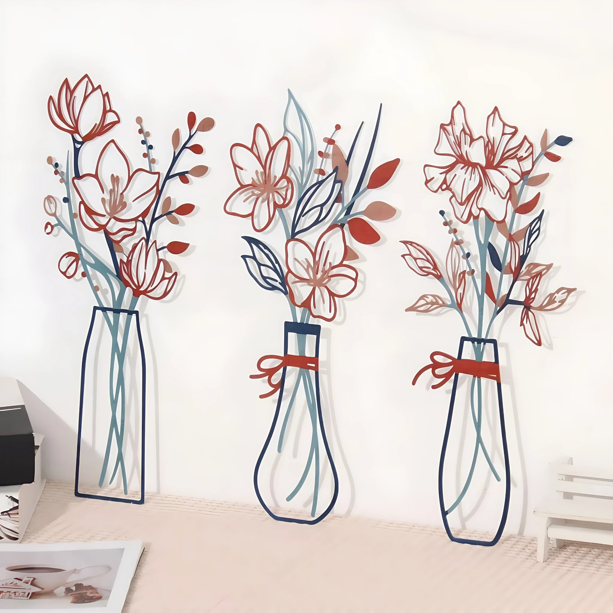 Set of three metal flower wall art pieces in country farmhouse style on a wall.