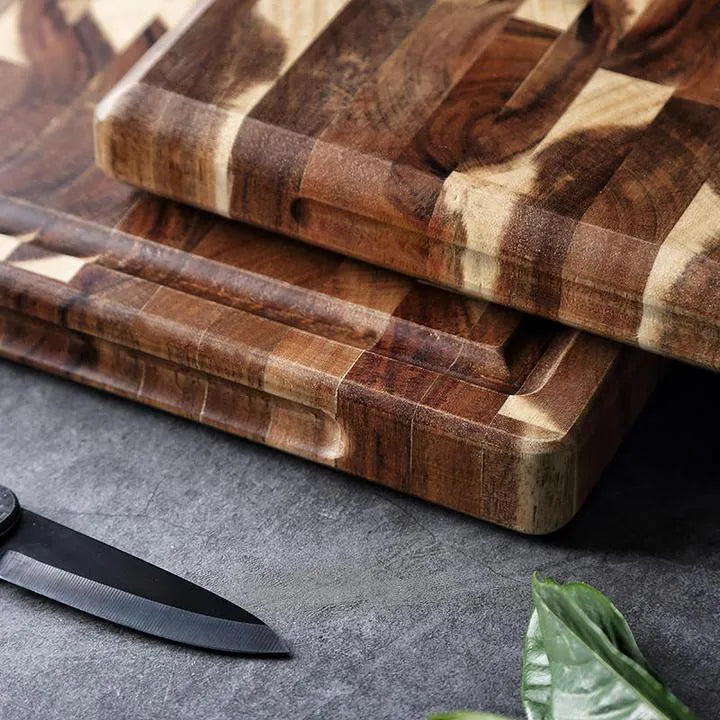 Brown solid acacia wood chopping board, 3cm thick, on a kitchen countertop.