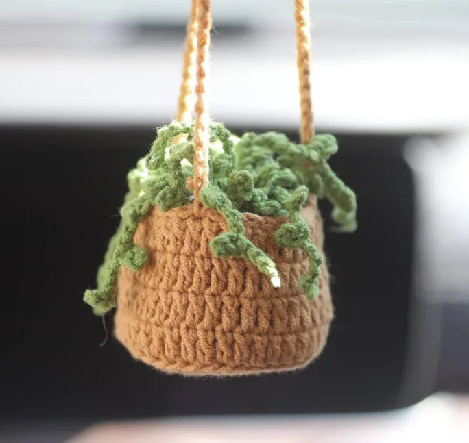 Green and white knitted wool car plant decoration with plastic base and hanging rope
