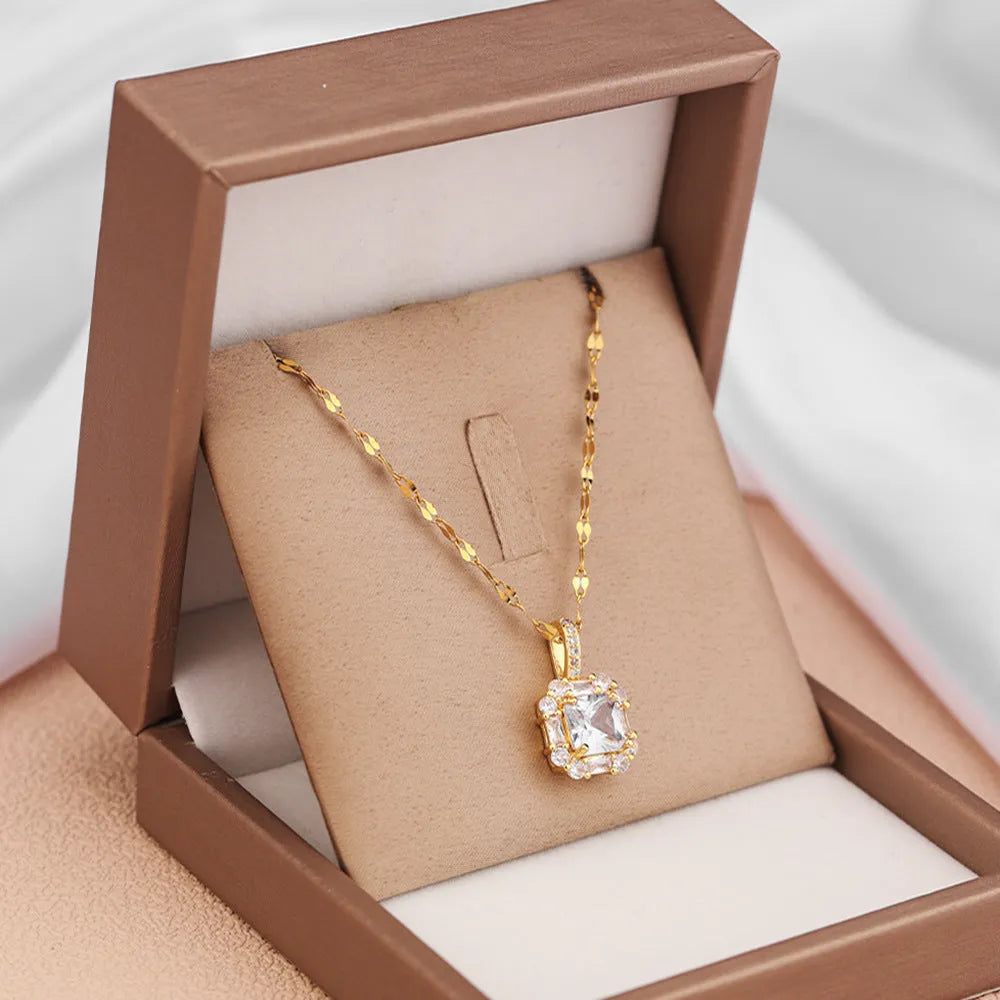 Gold geometric zircon inlaid pendant on a water wave chain necklace.