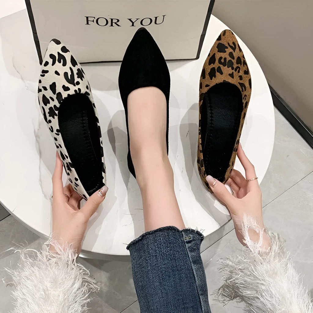 Women's leopard print flat pointed toe pumps with low heel on beige background