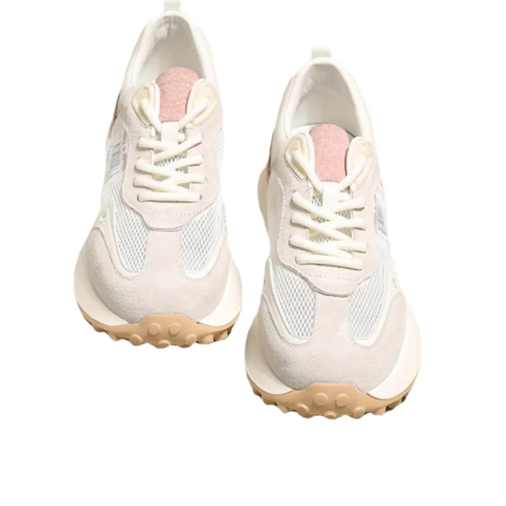 Grey and pink women's low-top retro sneaker with round toe and rubber sole on a white background.