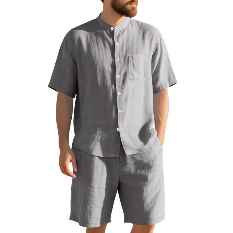 Men's light blue linen two-piece suit with short sleeve jacket and shorts on a hanger.