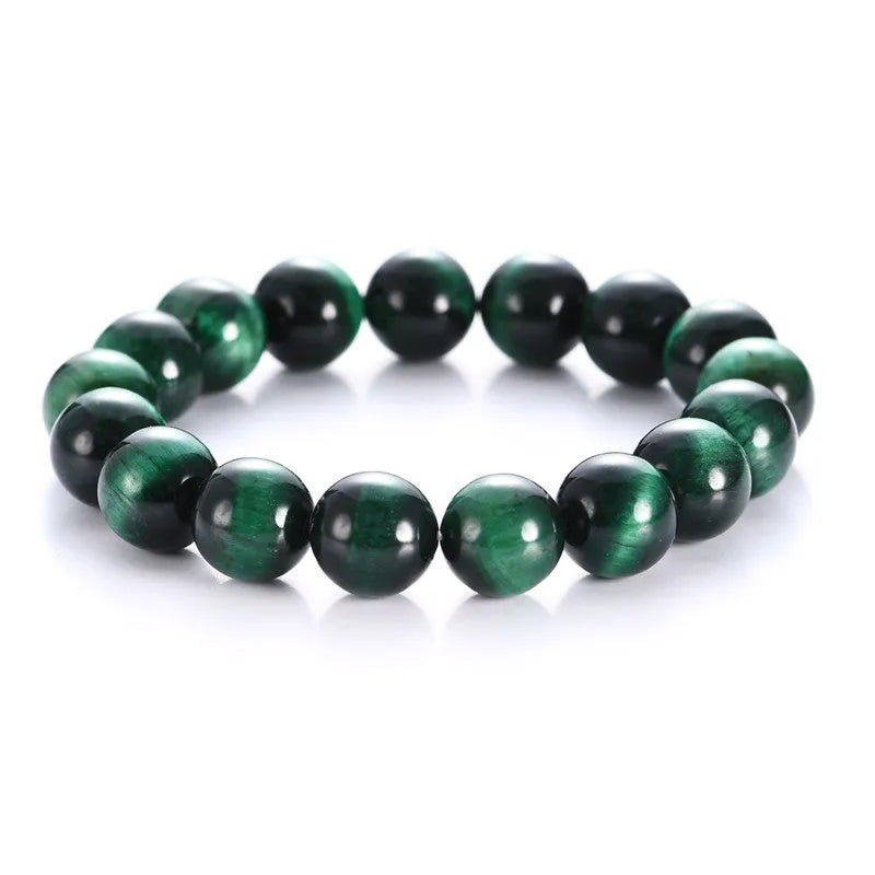 Green tiger eye gemstone bracelet with geometrically polished beads on a white background.
