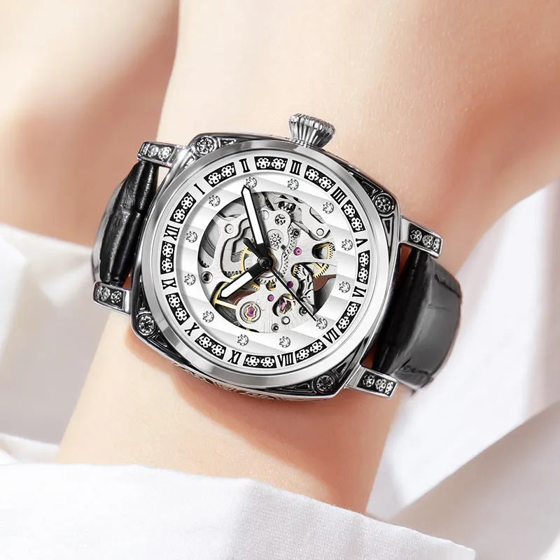 Leather strap mechanical wristwatch with luminous hands on a black dial.